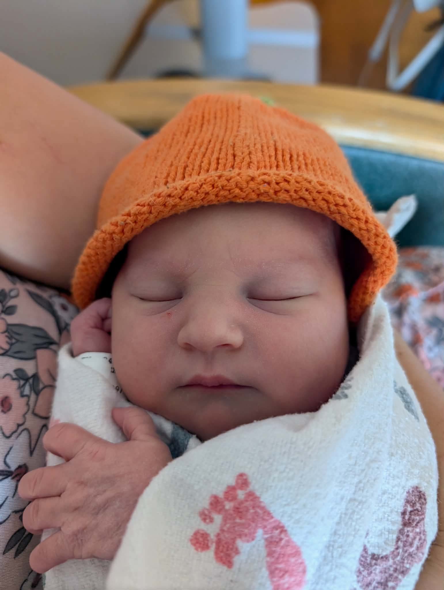 Axel Finley James Lobeck sleeping in an orange knit hat